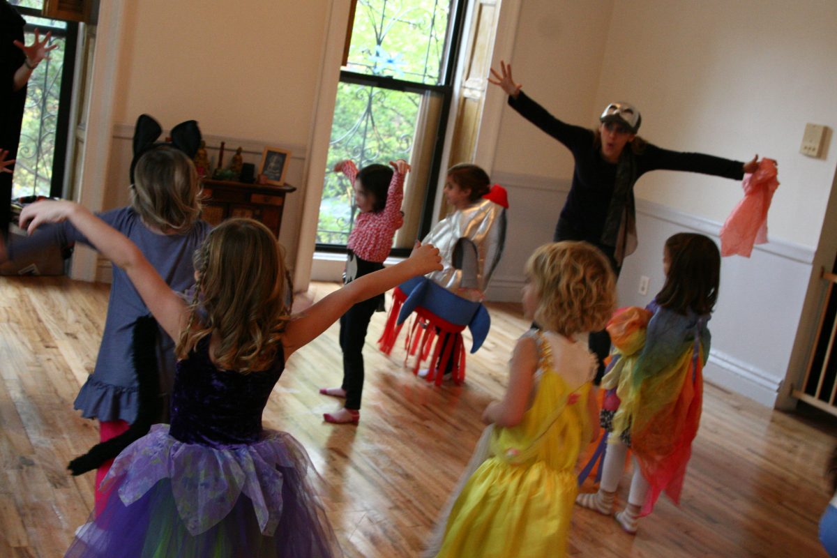 Teacher playing with kids dressed in costume, expressive movements with arms
